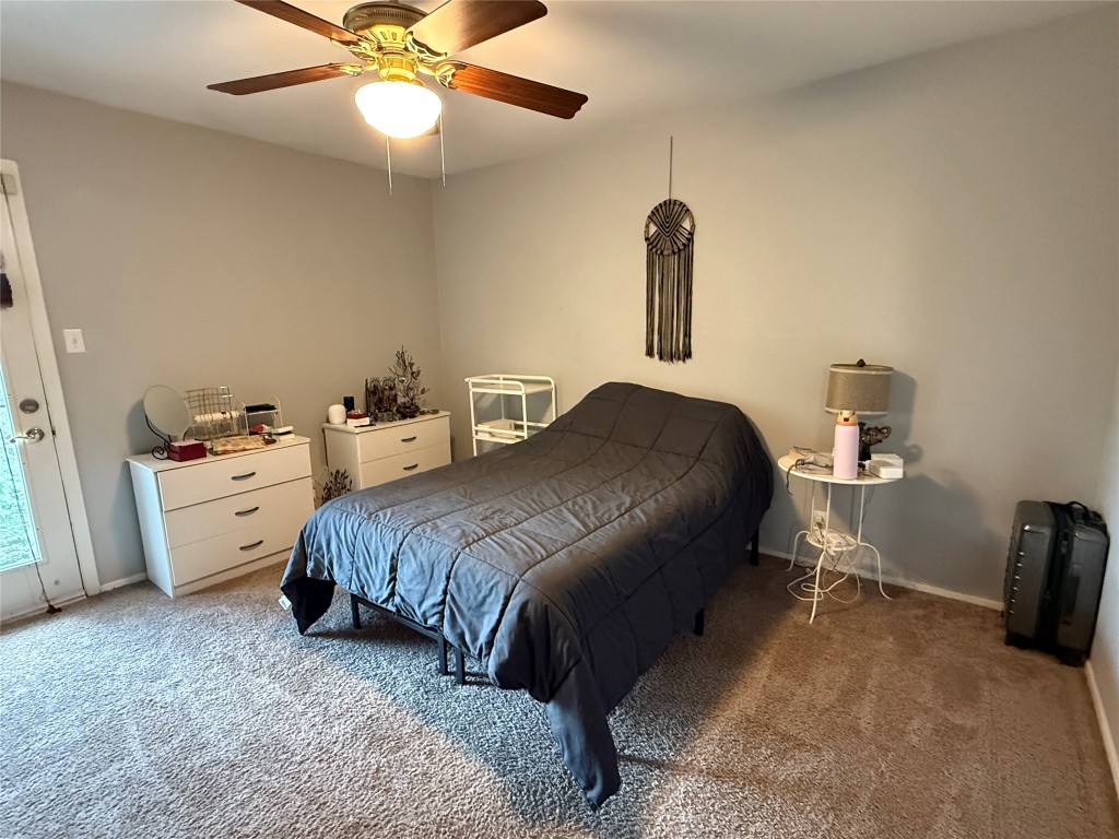 816 Ramble Lane, Unit B Austin, TX 78745 - Photo 16 of 27 a bedroom with a bed and a chandelier