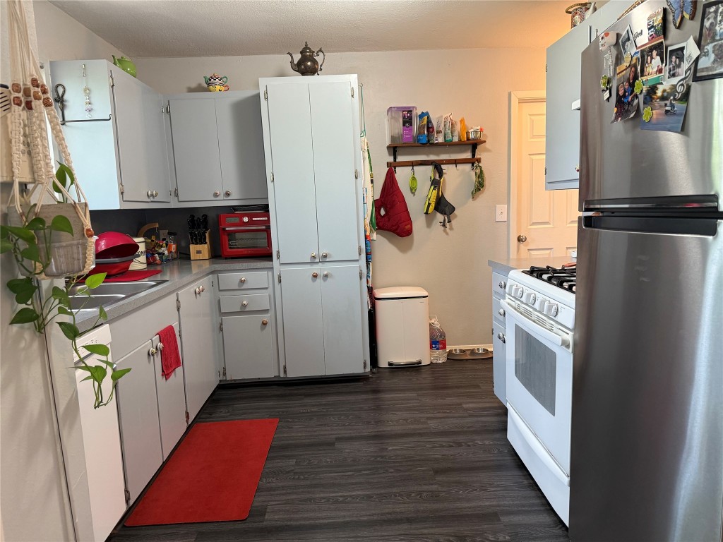 816 Ramble Lane, Unit B Austin, TX 78745 - Photo 10 of 27 a utility room with cabinets washer and dryer