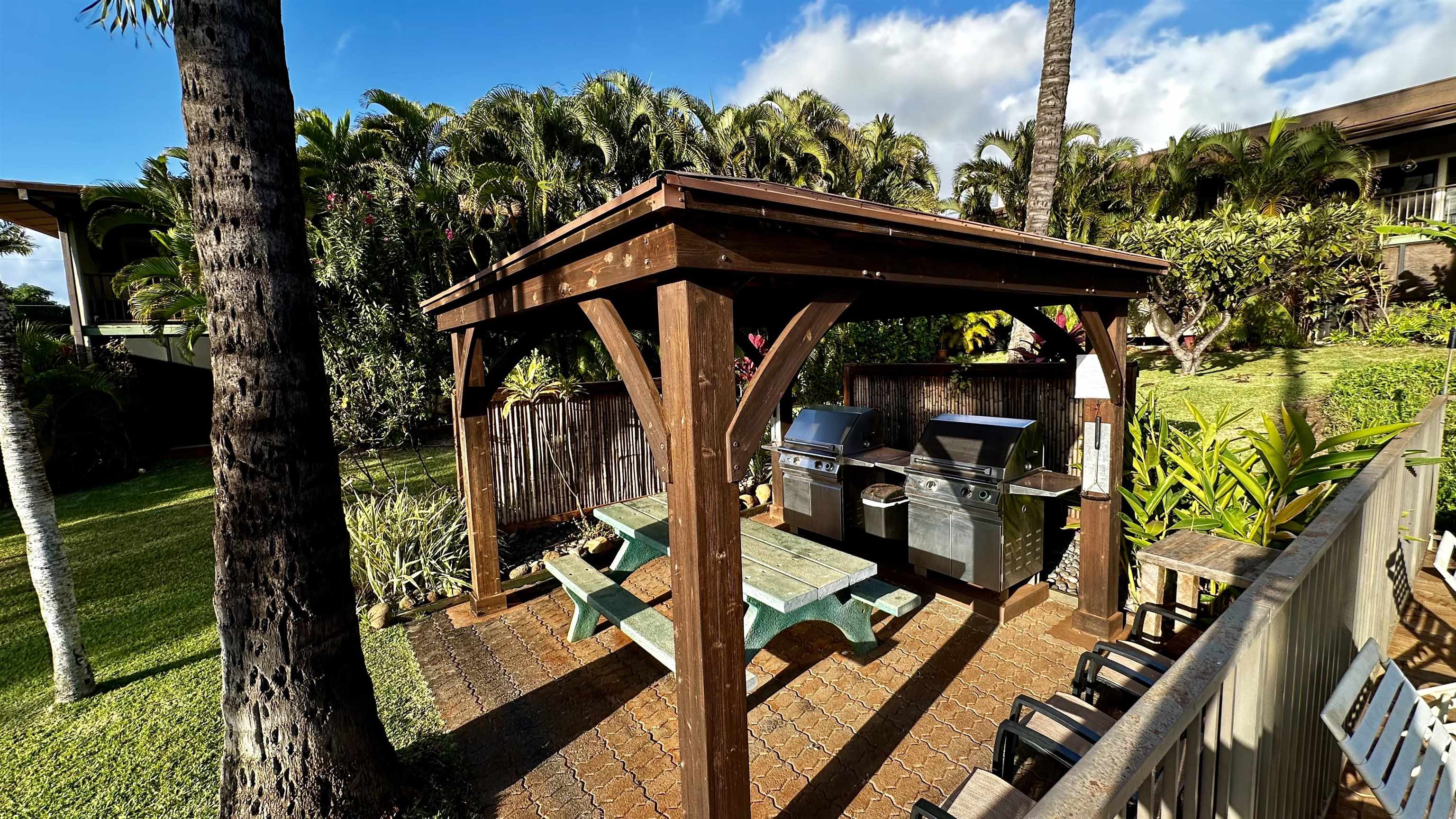 3788 Lower Honoapiilani Road, Unit A208 Lahaina, HI 96761 - Photo 22 of 23 a view of a patio with wooden floor and iron fence