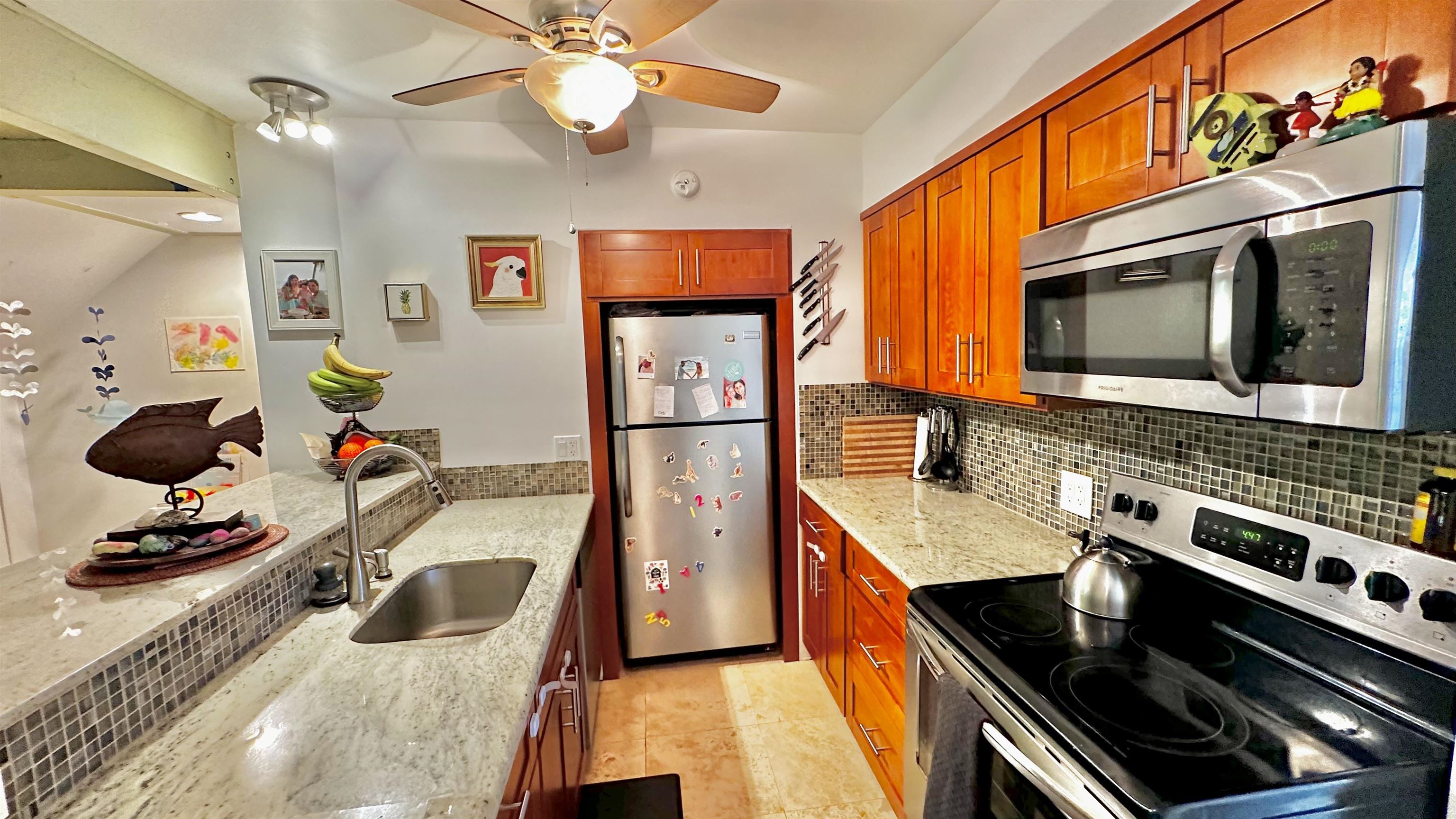 3788 Lower Honoapiilani Road, Unit A208 Lahaina, HI 96761 - Photo 3 of 23 a kitchen with a stove and a microwave