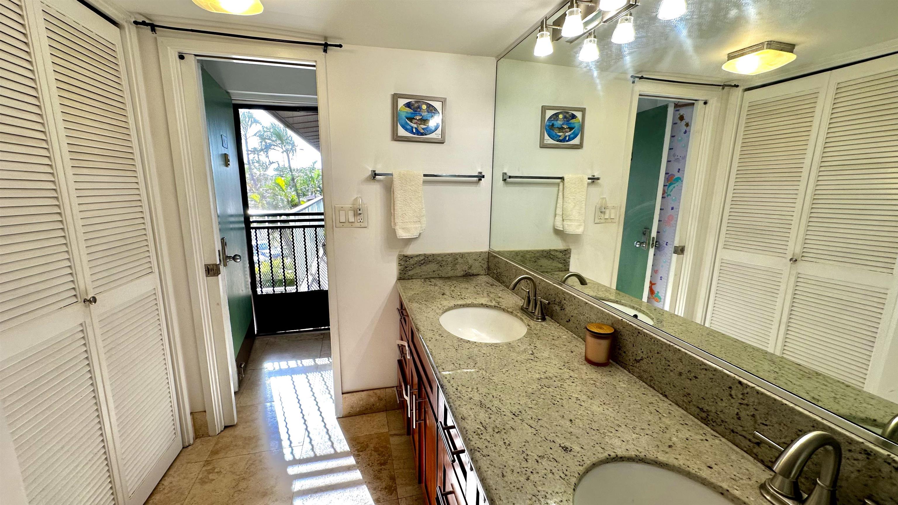 3788 Lower Honoapiilani Road, Unit A208 Lahaina, HI 96761 - Photo 9 of 23 a spacious bathroom with a granite countertop sink and a mirror