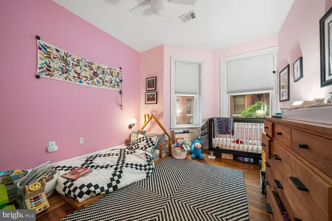 a bedroom with furniture and a window