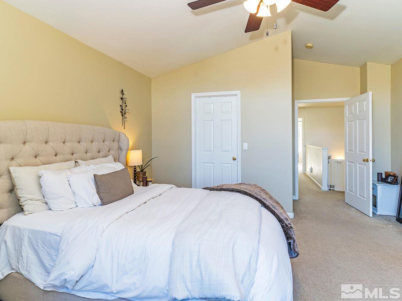 855 Caughlin Crossing Reno, NV 89519 - Photo 16 of 25 a bedroom with a bed and a chandelier