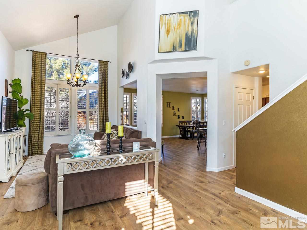 855 Caughlin Crossing Reno, NV 89519 - Photo 6 of 25 a living room with fireplace furniture and a floor to ceiling window