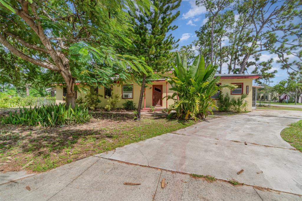 2729 Broadway Fort Myers, FL 33901 - Photo 1 of 49 a front view of a house with a yard and a garage