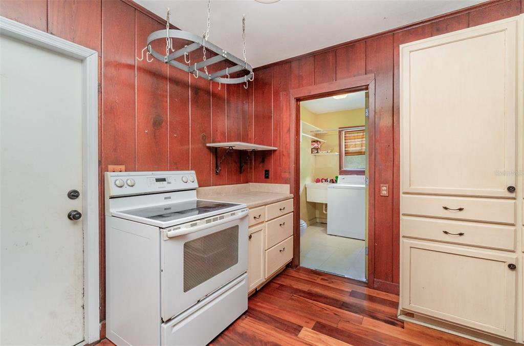 2729 Broadway Fort Myers, FL 33901 - Photo 13 of 49 a kitchen with a stove and a wooden floor