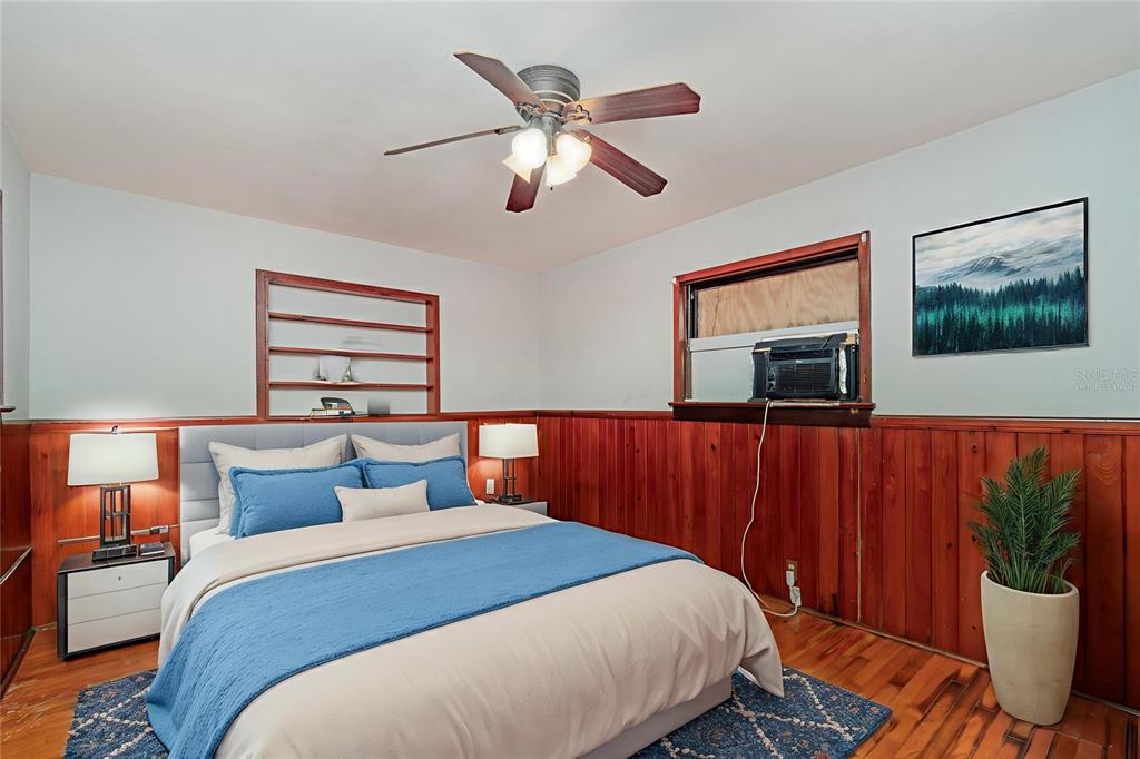 2729 Broadway Fort Myers, FL 33901 - Photo 15 of 49 a bedroom with a large bed and a chandelier