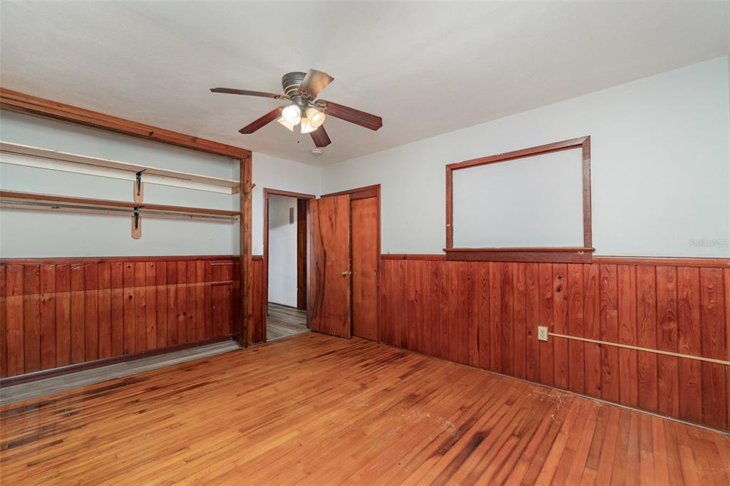 2729 Broadway Fort Myers, FL 33901 - Photo 17 of 49 a room with wooden floors and a chandelier fan