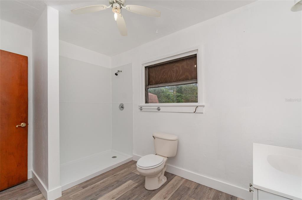 2729 Broadway Fort Myers, FL 33901 - Photo 18 of 49 a bathroom with a toilet a sink and mirror
