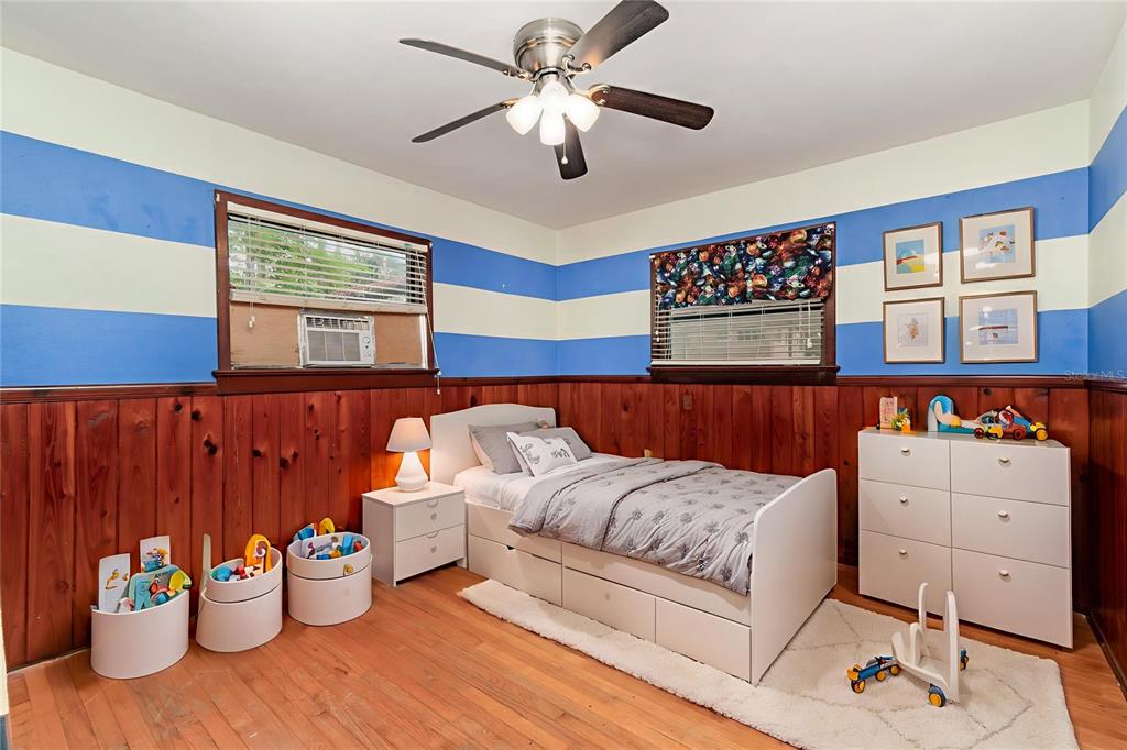 2729 Broadway Fort Myers, FL 33901 - Photo 21 of 49 a bedroom with a bed and a chandelier