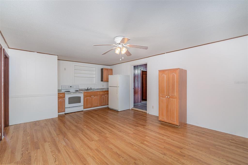 2729 Broadway Fort Myers, FL 33901 - Photo 25 of 49 a view of a kitchen with wooden floor and a ceiling fan
