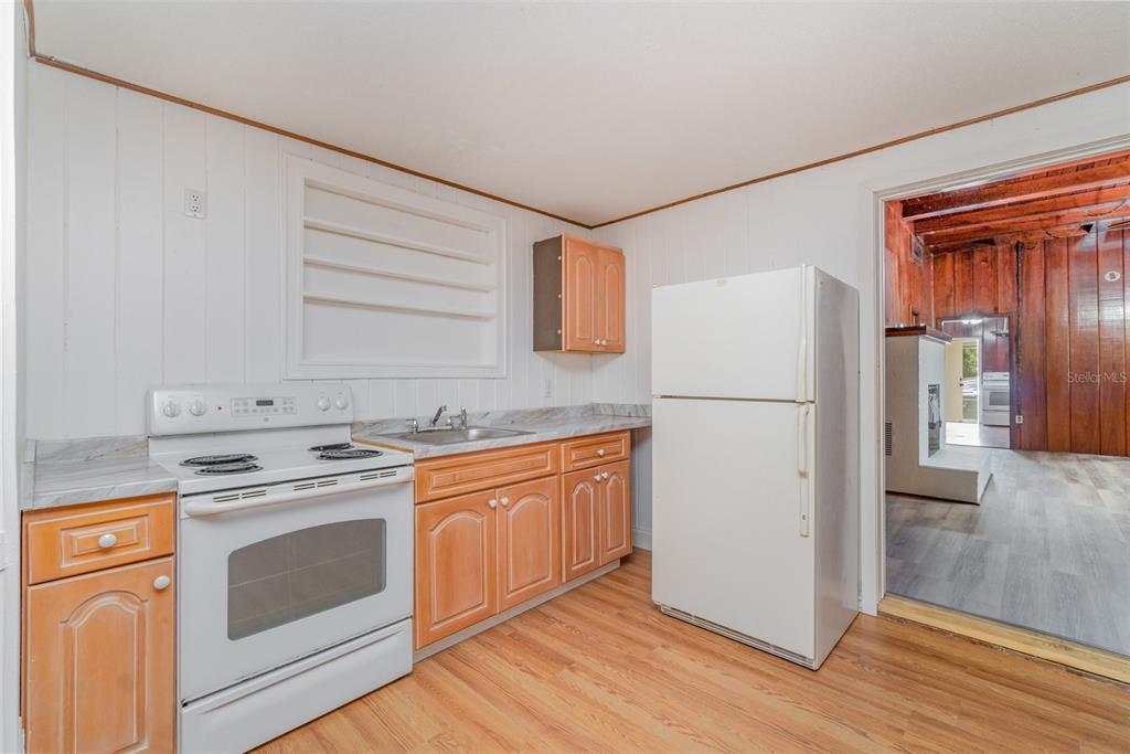 2729 Broadway Fort Myers, FL 33901 - Photo 26 of 49 a kitchen with a stove top oven and refrigerator