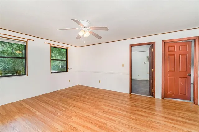 a view of a workspace with furniture window and wooden floor