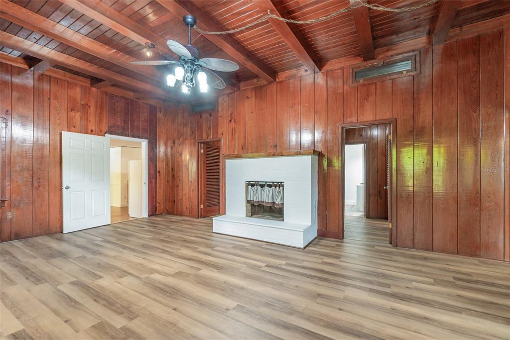 2729 Broadway Fort Myers, FL 33901 - Photo 3 of 49 a view of an empty room with wooden floor and a kitchen