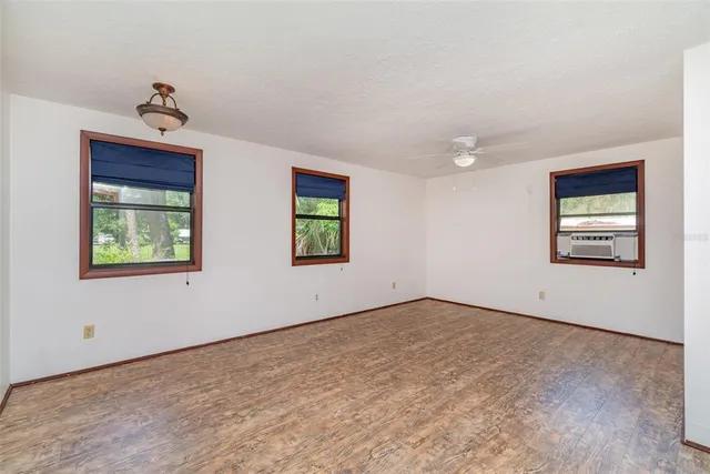 a bathroom with a granite countertop sink toilet a mirror and shower