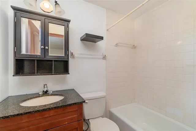 a dining room with furniture and a large window