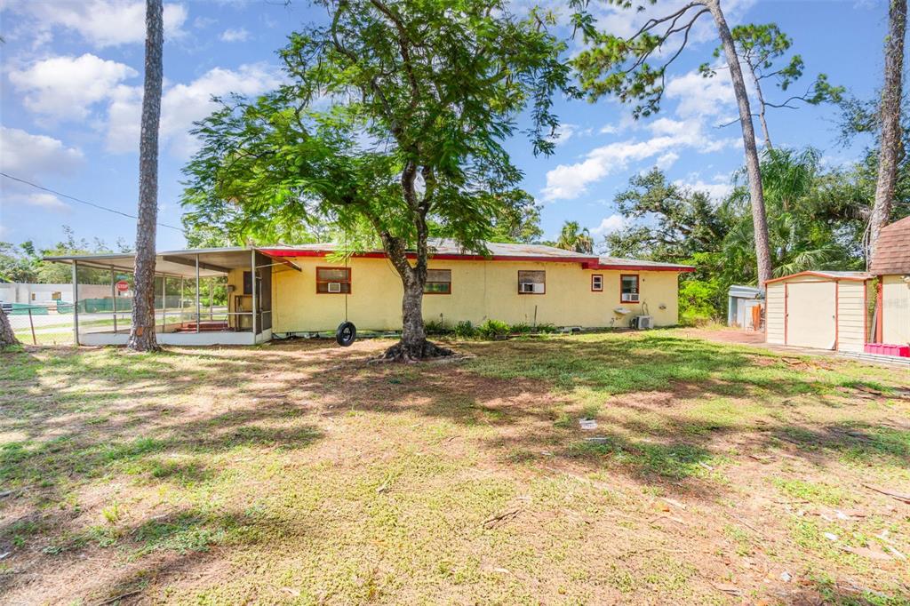 2729 Broadway Fort Myers, FL 33901 - Photo 41 of 49 a view of a house with backyard and a tree