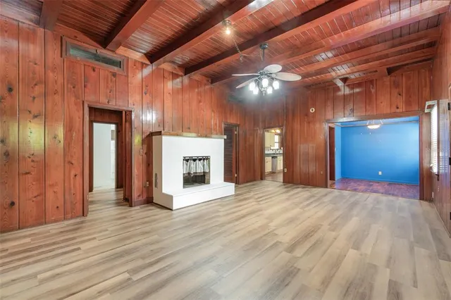 a view of empty room with wooden floor and fireplace