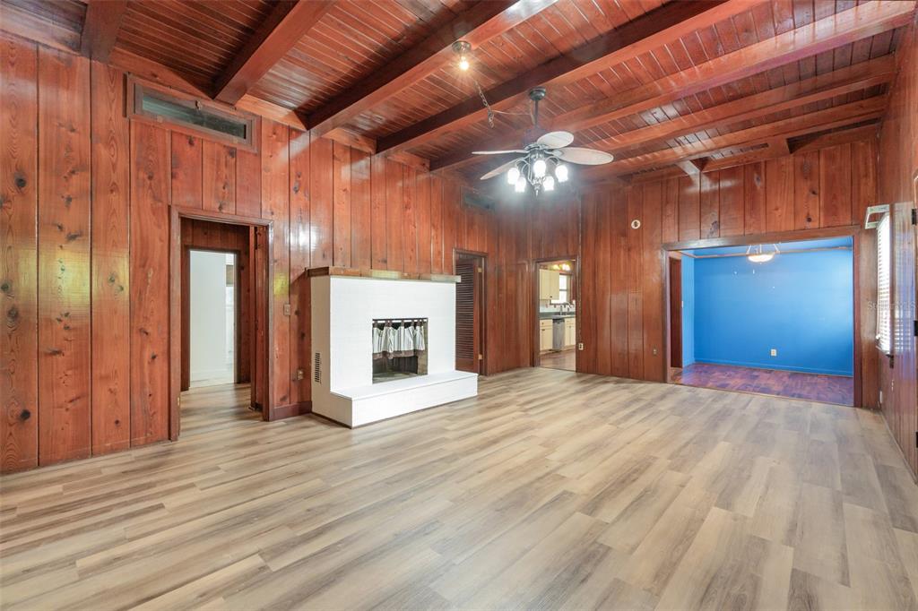 2729 Broadway Fort Myers, FL 33901 - Photo 5 of 49 a view of empty room with wooden floor and fireplace