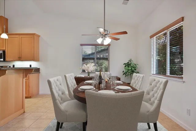 a dining room with furniture potted plants and a chandelier