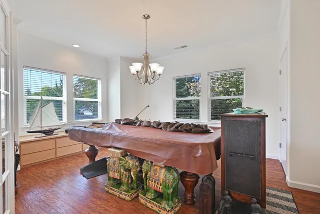 a dining room with furniture a window and wooden floor