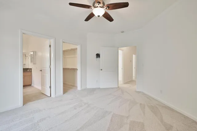a view of empty room with ceiling fan
