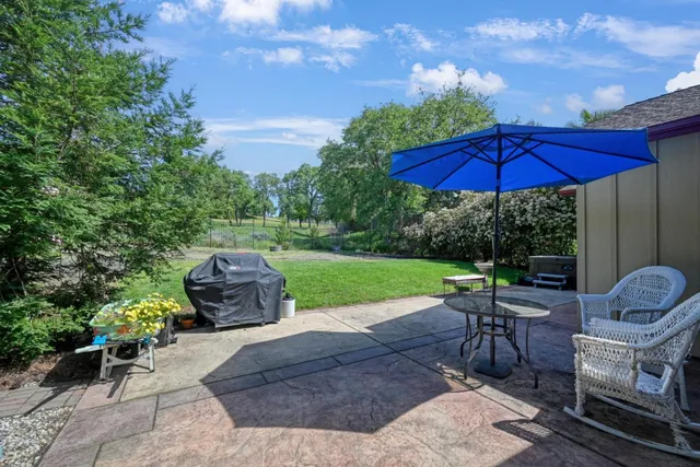 a view of a table and chairs under an umbrella in the patio