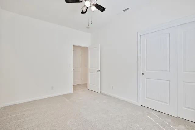 an empty room with a empty space and a ceiling fan
