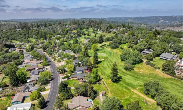 an aerial view of a houses with a yard