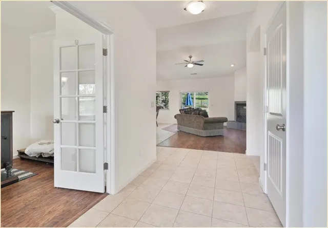 a living room with furniture and a hallway
