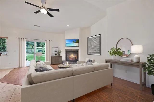 a living room with furniture fireplace and window