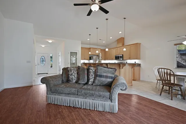 a living room with furniture and kitchen view