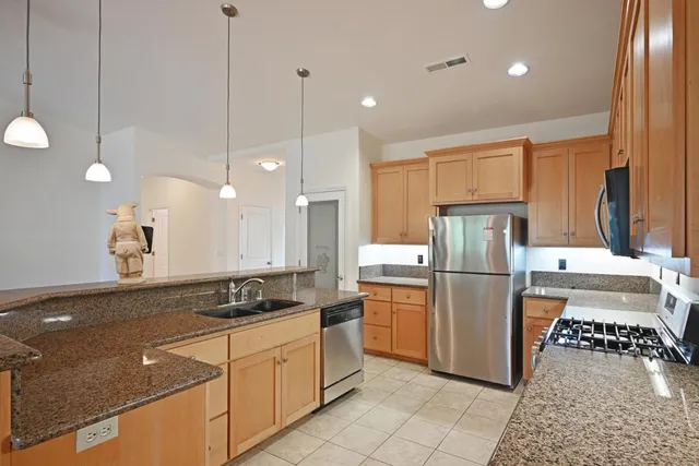 a kitchen with refrigerator and cabinets