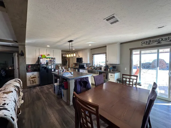 a large kitchen with a table and chairs
