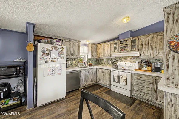 a kitchen with stainless steel appliances a refrigerator and cabinets
