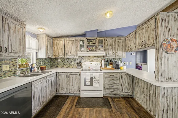 a kitchen with stainless steel appliances granite countertop a sink and cabinets
