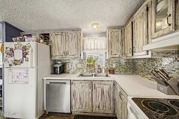 a kitchen with a sink a stove and cabinets