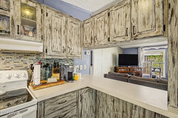 a kitchen with a stove a sink and a microwave