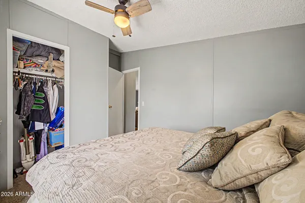 a bedroom with a bed and a chandelier