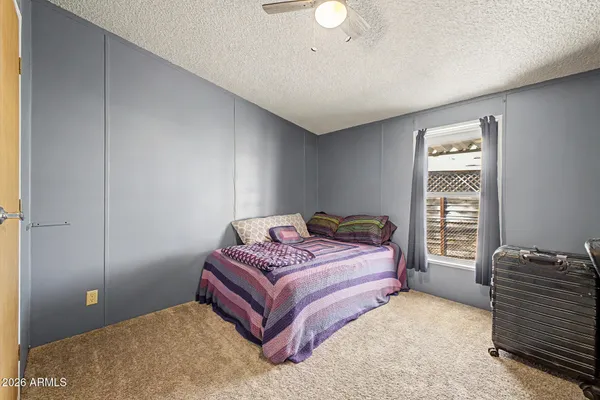 a bedroom with a bed and with furniture