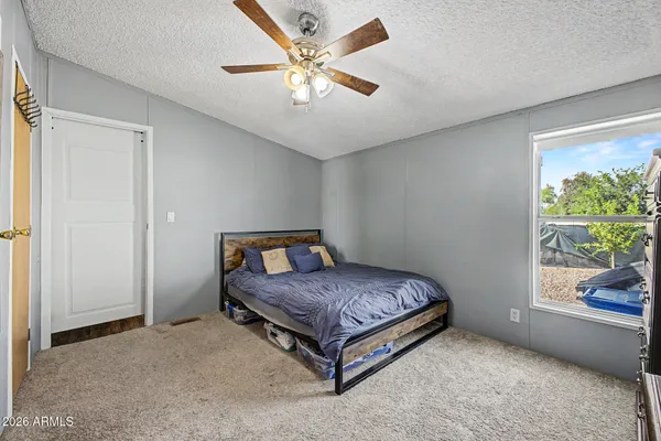 a bedroom with a bed and a large window