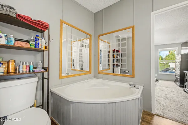 a white bath tub sitting next to a white toilet
