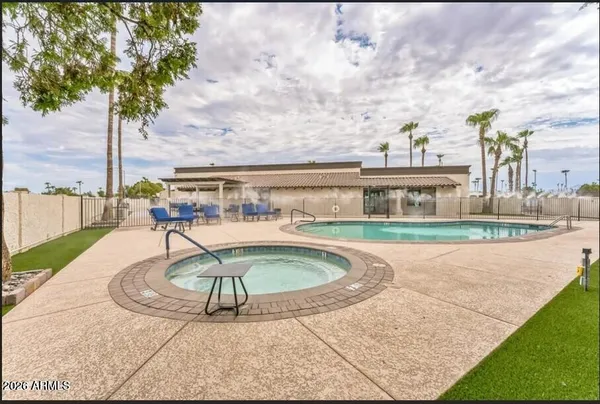 a swimming pool with outdoor seating and yard