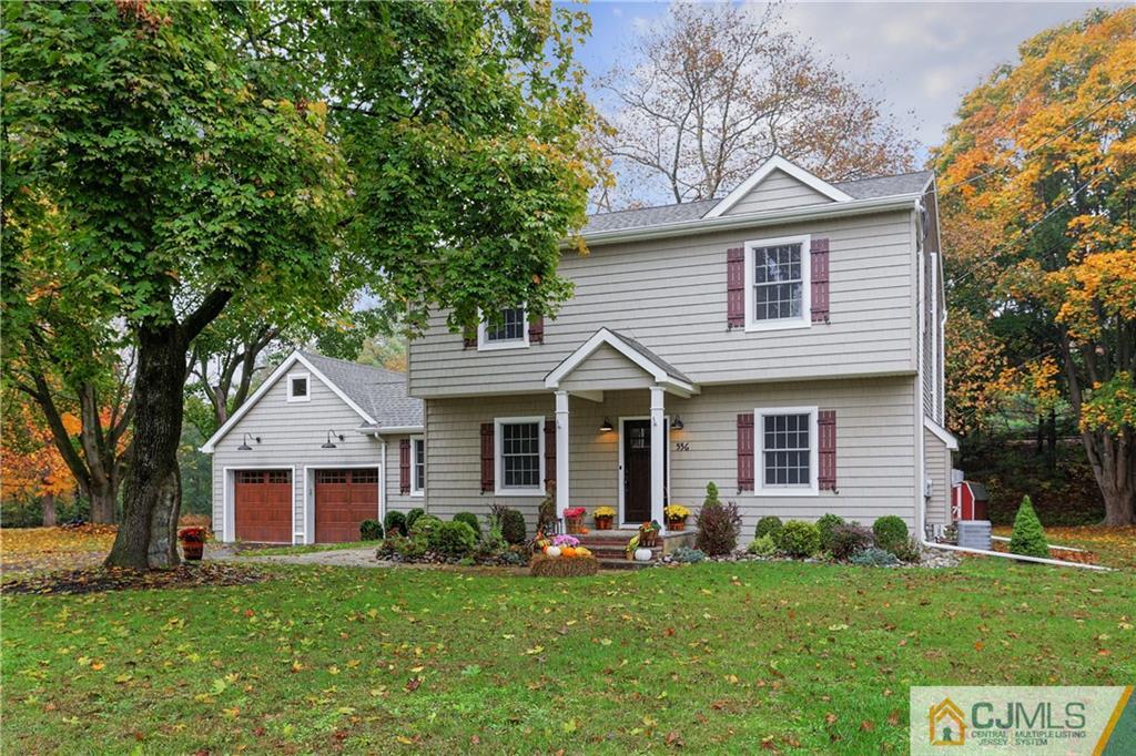 556 Ridge Road Monmouth Junction, NJ 08852 - Photo 1 of 19 a front view of a house with a yard and garage