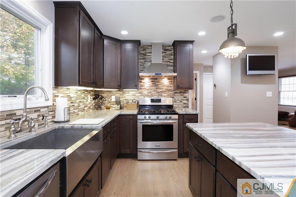 556 Ridge Road Monmouth Junction, NJ 08852 - Photo 2 of 19 a kitchen with kitchen island granite countertop a sink stove and refrigerator