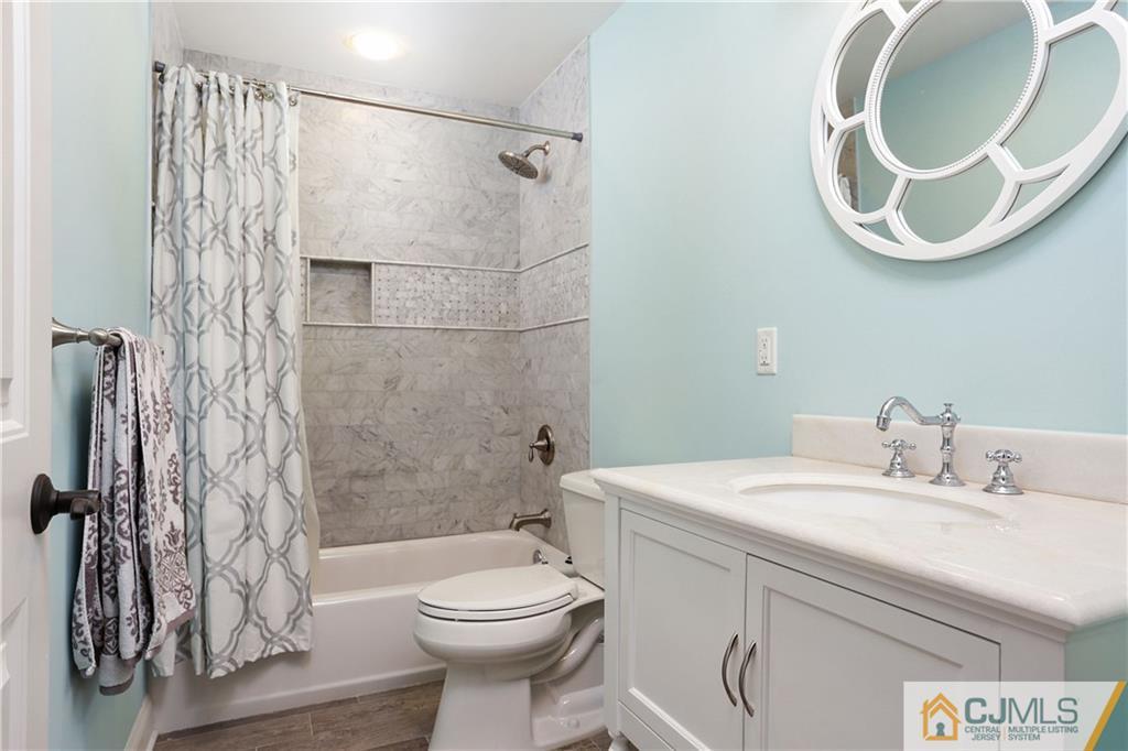 556 Ridge Road Monmouth Junction, NJ 08852 - Photo 11 of 19 a bathroom with a sink a toilet and a mirror