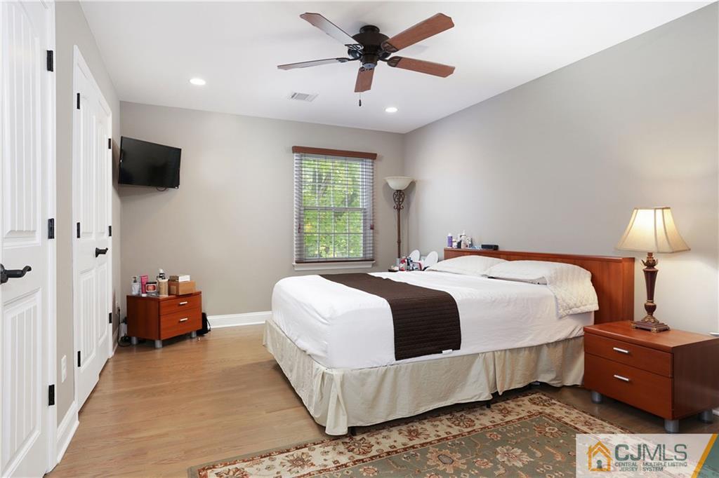 556 Ridge Road Monmouth Junction, NJ 08852 - Photo 12 of 19 a bedroom with a bed and a chandelier