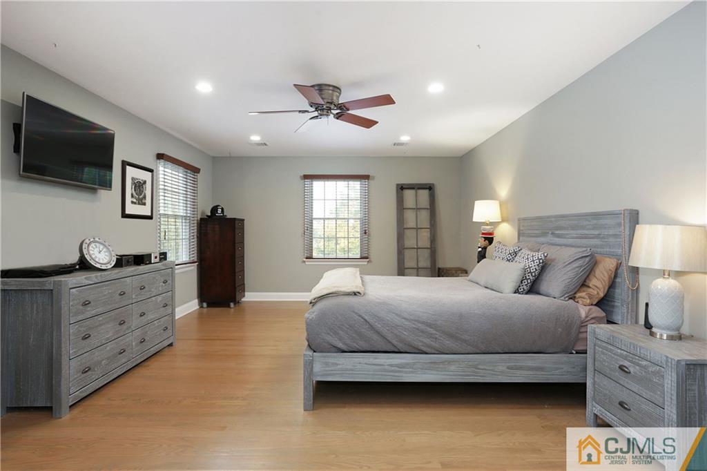 556 Ridge Road Monmouth Junction, NJ 08852 - Photo 13 of 19 a bedroom with a bed and a flat screen tv