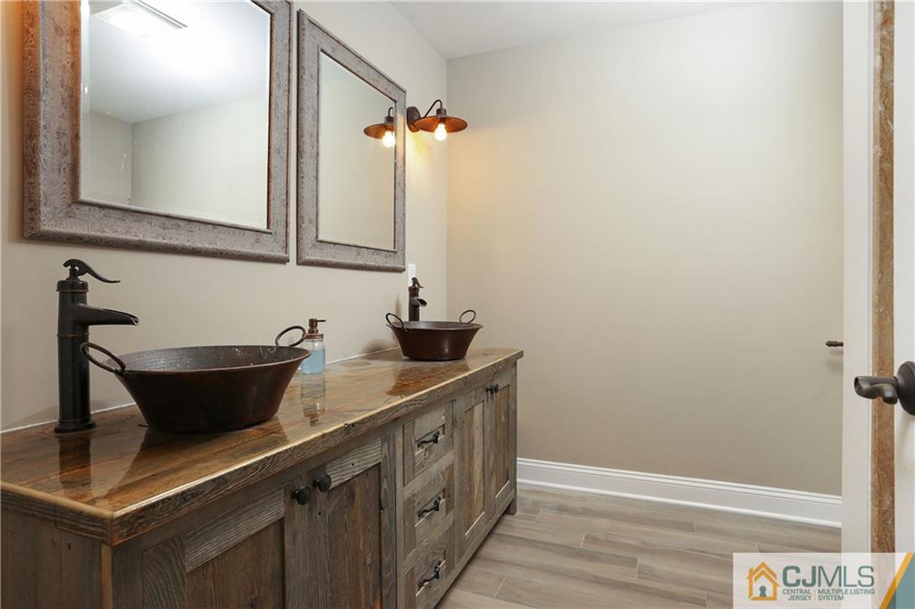 556 Ridge Road Monmouth Junction, NJ 08852 - Photo 14 of 19 a bathroom with a sink and a mirror