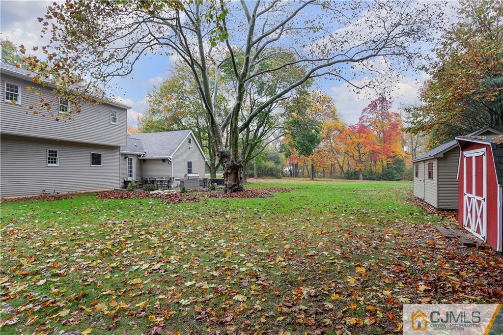 556 Ridge Road Monmouth Junction, NJ 08852 - Photo 18 of 19 a view of a house with backyard and garden
